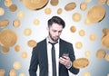 Bearded businessman looking at phone, bitcoin rain Royalty Free Stock Photo