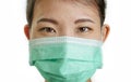 Close up portrait of young beautiful and attractive Asian Korean woman wearing blue protective face mask looking to the camera Royalty Free Stock Photo