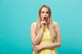 Close up Portrait young beautiful attractive girl shocking with something. Blue Pastel Background. Copy space.