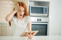 Redhair girl happy smiling on digital table with wining something Royalty Free Stock Photo