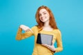 Close up Portrait young beautiful attractive redhair girl smiling showing digital tablet screen on black. Blue Pastel Royalty Free Stock Photo