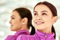 Close up portrait of a young beautiful caucasian woman, female fitness instructor in sportswear looking away and smiling Royalty Free Stock Photo