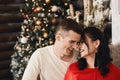 Close up portrait of a young beautiful couple of lovers, happy brunette girl in red dress and smiling handsome man Royalty Free Stock Photo