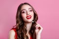 Close-up portrait of young beautiful girl.Perfect toothy smile. Red lips and perfect skin on pink background Royalty Free Stock Photo