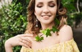 Close-up portrait of young beautiful girl with curly hair summer dress in tropical forest Royalty Free Stock Photo