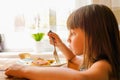 Close up portrait of young beautiful girl eating cheesecakes for breakfast Royalty Free Stock Photo