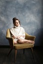 Close up portrait of young beautiful pensive girl in white sweater looking at window. Royalty Free Stock Photo