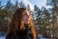 Close up portrait of a young beautiful red hair european girl in the winter forest Royalty Free Stock Photo