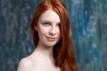 Close-up portrait of a young beautiful red-haired girl with clean white skin. skin care concept, healthy skin and hair. Royalty Free Stock Photo