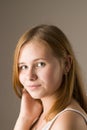 Close-up portrait of a young beautiful red-haired girl smiling while looking at the camera. Royalty Free Stock Photo