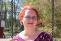 Close up portrait, Young beautiful red haired woman posing outdoors in sunny weather Royalty Free Stock Photo