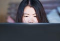 Close up portrait of young beautiful 20s Asian Chinese woman lying on bed at night using internet in laptop computer watching on l Royalty Free Stock Photo