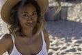 Close up portrait of a young beautiful Thai woman wearing a wooden hat and stylish necklace relaxing alone on the beach near the Royalty Free Stock Photo