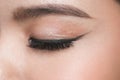 Close-up portrait of young beautiful woman`s closed, eye zone make up with black arrow Royalty Free Stock Photo