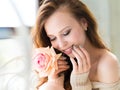 Close-up portrait of young beautiful woman smile mouth with pink rose flower and touch her face. Skin care and woman`s Royalty Free Stock Photo