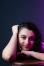 Close-up portrait of young beautiful woman smiling with one hand in her hair and the other on her chin Royalty Free Stock Photo