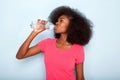 Close up young black woman drinking bottle of water