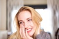 Close up young blond woman laughing at home Royalty Free Stock Photo