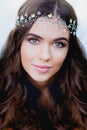 Close-up portrait of young brunette European type, with long curly hair and the decoration on the Royalty Free Stock Photo