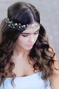 Close-up portrait of young brunette European type, with long curly hair and the decoration on the Royalty Free Stock Photo