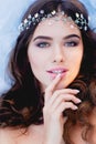 Close-up portrait of young brunette European type, with long curly hair and the decoration on the Royalty Free Stock Photo