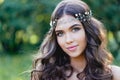 Close-up portrait of young brunette European type, with long curly hair and the decoration on the Royalty Free Stock Photo