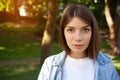 Close-up portrait young brunette student girl outdoor wearing white t-shirt Royalty Free Stock Photo