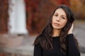 Close up Portrait of a young brunette woman against the background of a burgundy autumn landscape Royalty Free Stock Photo