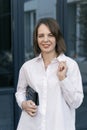 Close up portrait of young business woman in white shirt. Business attire, semi-casual. Vertical frame Royalty Free Stock Photo