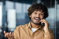 Close up portrait of young businessman, man talking cheerfully and smiling friendly and looking at camera, hispanic man Royalty Free Stock Photo