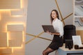 Portrait of a young businesswoman working on a laptop in an modern office Royalty Free Stock Photo