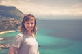 Close-up portrait of young caucasian girl traveler with grey t-shirt and sunglasses looking at camera Royalty Free Stock Photo