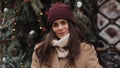 Close Up Portrait of Young Charming Brunnete Girl Wearing in Hat and Mittens Waving Looking to Camera and Smiling