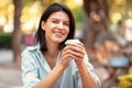 Close up portrait of young charming woman enjoying her morning coffee outdoors in park Royalty Free Stock Photo