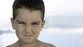 Close up portrait of young child boy making grimace emotional expressing disgust face grimacing looking at camera copy space Royalty Free Stock Photo