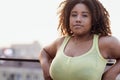 Close-up of portrait of young curvy attractive African. Charming dark girl in yellow top