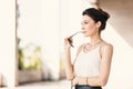 Close-up portrait of young, elegant brunette woman in cream silk blouse and leather skirt Royalty Free Stock Photo