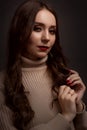 portrait of a young elegant woman with long brown hair, dressed in a knitted sweater Royalty Free Stock Photo