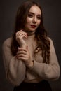 portrait of a young elegant woman with long brown hair, dressed in a knitted sweater Royalty Free Stock Photo