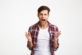 Close-up portrait of young emotional screaming man standing with