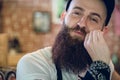 Close-up portrait of a young and fashionable male hairstylist