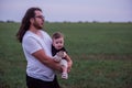 Close up portrait of young father with long hair, beard, glasses holds little son. Fathers day Royalty Free Stock Photo