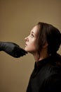 Close-up portrait of young female face is touched by doctors in gloves, preparing her for plastic surgery or beautican procedures Royalty Free Stock Photo