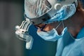 Close up portrait of young female surgeon doctor wearing protective mask and hat during the operation. Healthcare Royalty Free Stock Photo