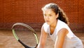 Close up portrait of young female tennis player concentrating on her game