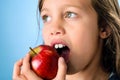 Close up portrait of a young girl eating an apple Royalty Free Stock Photo