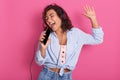 Close up portrait of young girl listening, enjoying music and holding cellular mp3 player in hand like microphone, wearing dance Royalty Free Stock Photo