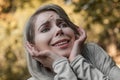 Close up portrait of a young girl with a naive and cute facial expression