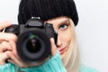 Close-up portrait of young girl taking photo on DSLR camera against white background. Royalty Free Stock Photo