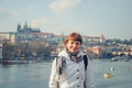 Close-up portrait of young girl tourist looking at camera and smile, Vltava river, Prague Castle Royalty Free Stock Photo